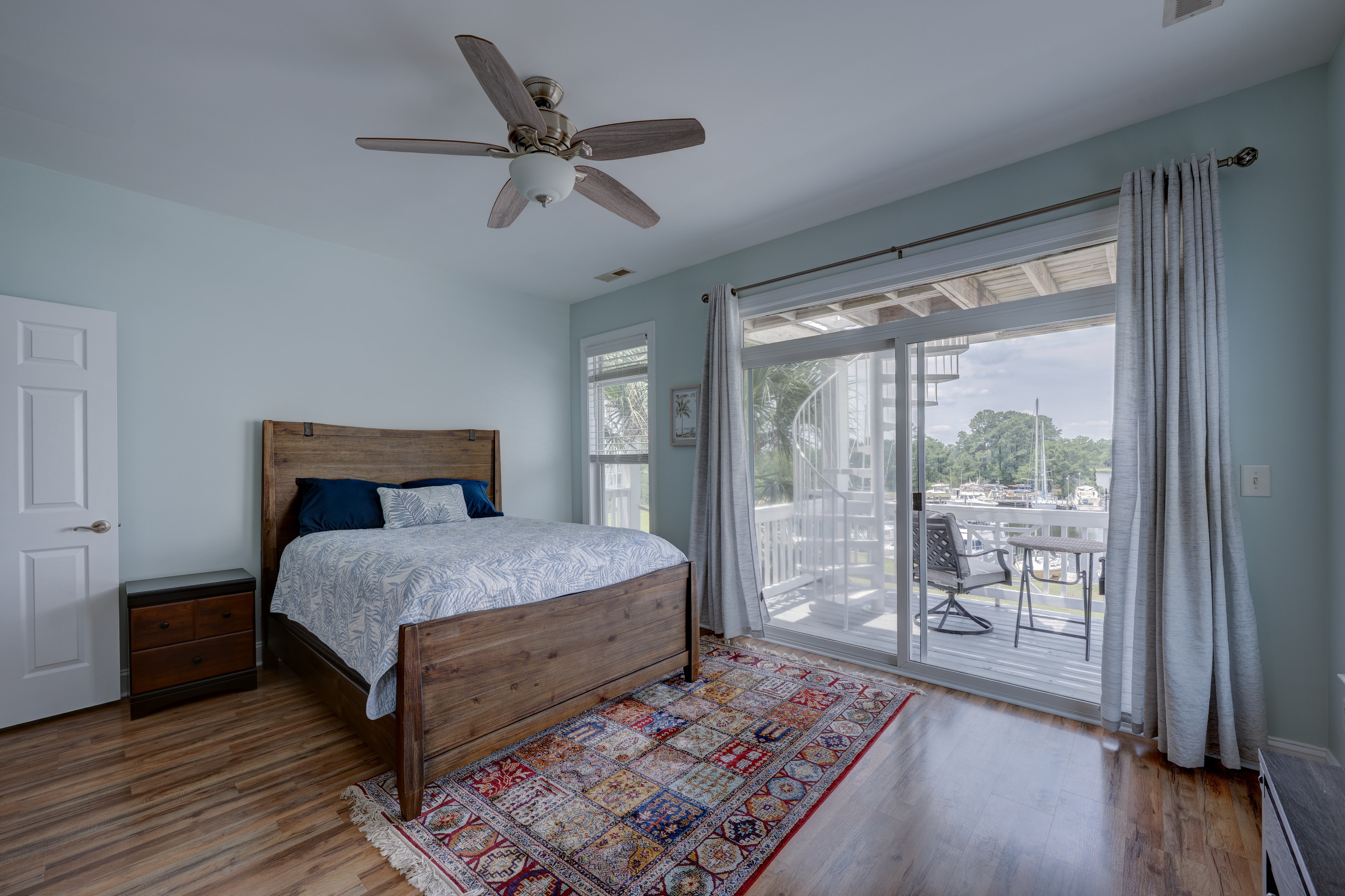 Master bedroom with marina view through sliding glass doors to the deck